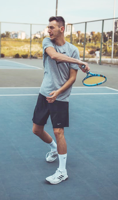 Photo of man playing tennis